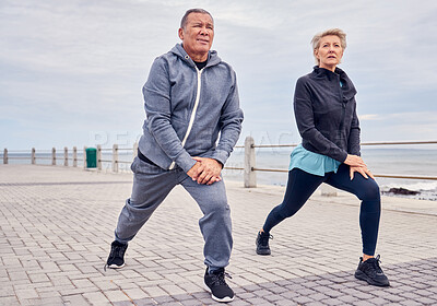 Buy stock photo Stretching legs, fitness and senior couple by ocean for exercise, healthy body and wellness in retirement. Sports, pilates and elderly man and woman ready for warm up, cardio workout and training