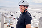 Happy, senior and man by the beach for cycling, training and eco friendly travel in Portugal. Fitness, smile and an elderly person enjoying retirement with a bike ride by the ocean for exercise