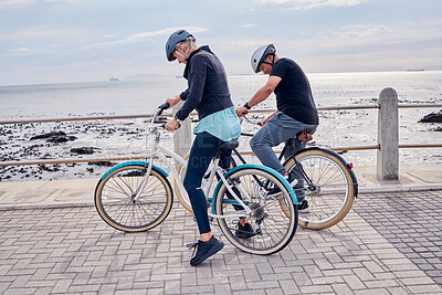 Buy stock photo Bike, cycling and fitness with a senior couple on the promenade, riding eco friendly transport for travel. Bicycle, beach or exercise with a mature man and woman cyclist out on a ride for tourism