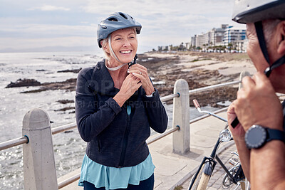 Buy stock photo Helmet, happy and a senior couple cycling outdoor together for fitness or an active lifestyle. Summer, exercise or smile with a mature man and woman bonding on the beach promenade during a cycle