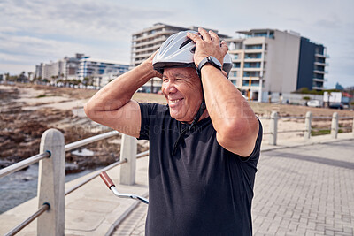 Buy stock photo Senior man, smile and helmet at the beach with bicycle for weekend, trip or holiday travel in Cape Town. Happy elderly male biker or cyclist smiling for cycling, journey or break by the ocean coast