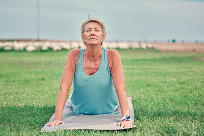 Buy stock photo Cobra stretching, senior woman and exercise at park for workout, training and fitness. Elderly lady, yoga and flexible body outdoor on mat, grass and nature for wellness, healthy lifestyle or push up