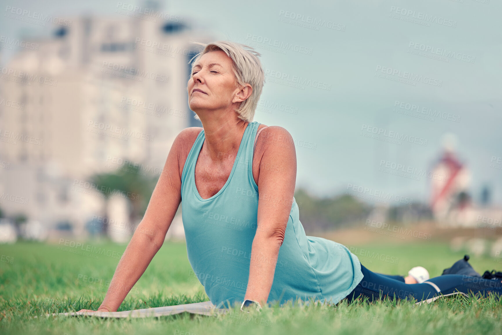 Buy stock photo Cobra stretching, senior woman and yoga on grass for workout, training and fitness. Elderly lady, pilates exercise and flexible body outdoor on mat, nature and wellness, healthy lifestyle and push up