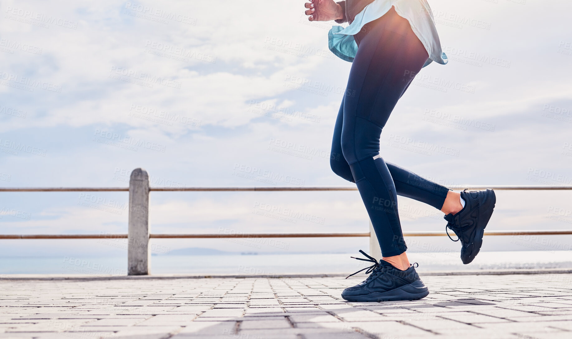 Buy stock photo Legs of woman, fitness and running at promenade beach for energy, wellness and sky mockup. Closeup lady, runner shoes and outdoor exercise at sea for marathon training, sports and workout performance