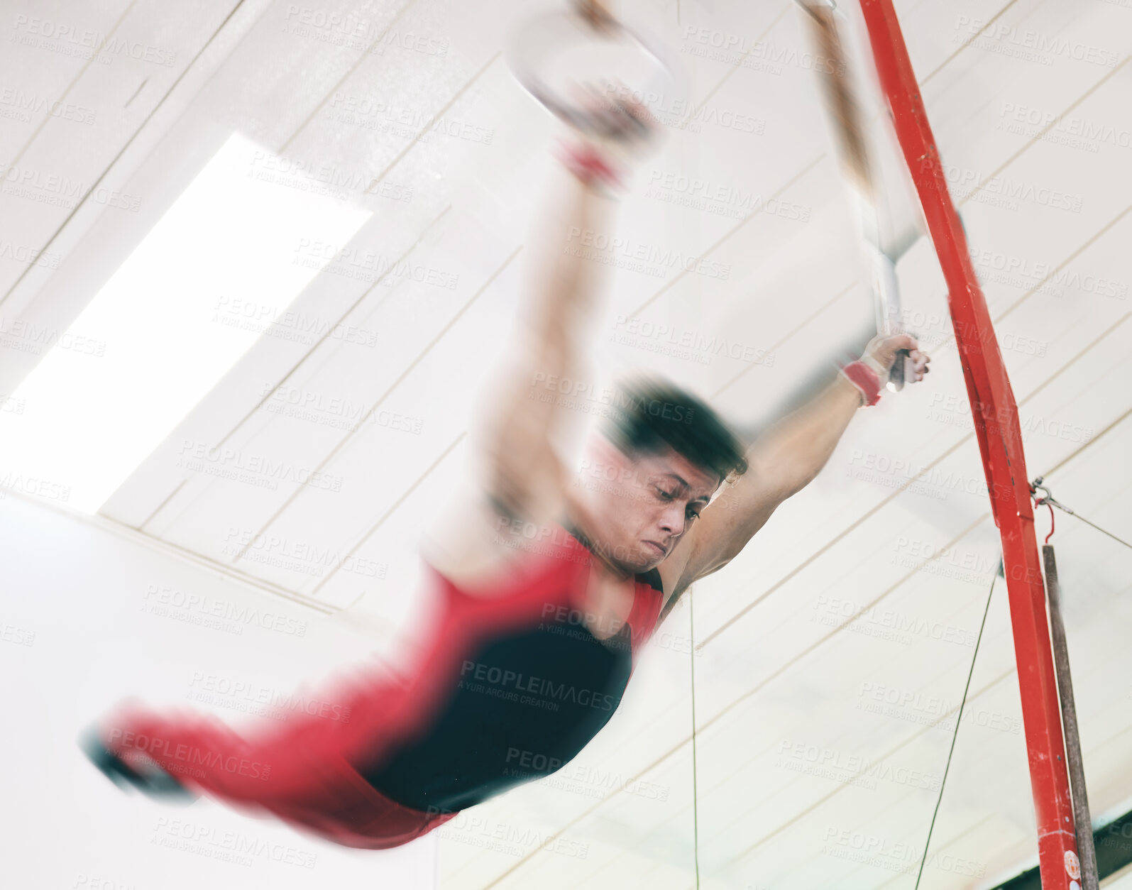 Buy stock photo Gymnastics, ring and fitness with man in stadium and focus for sports, workout or health. Wellness, exercise and training with athlete and still rings in gym arena for strong, power and motion blur