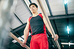 Gymnastics, fitness and man training in a studio for a competition, performance or show. Sports, athlete and male gymnast practicing for flexibility, agility or strength for balance at event in arena