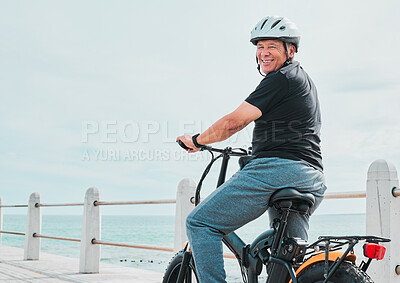 Buy stock photo Electric bike, portrait or travel with a senior man on a promenade, riding eco friendly transport by the beach. Sustainability, cycling or mock up with a mature male tourist by the seaside for a ride