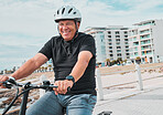 Mature man, helmet or electrical bike by beach for future fitness, clean energy transport or sustainability travel. Happy person, technology or electric bicycle, head safety or eco friendly cycling