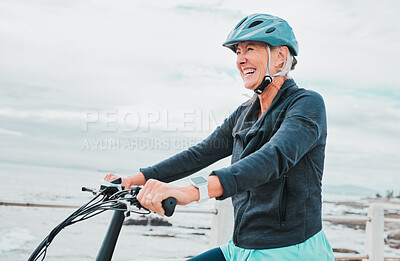 Buy stock photo Senior woman, bike and smile in cycling by the beach for fun activity or travel in the city. Happy elderly woman smiling and enjoying cruise on bicycle for traveling, trip or fitness by ocean coast