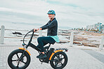 Fitness, senior woman and bicycle on promenade, exercise and training for wellness, beach and break. Mature female, elderly lady and biker commute, travel and workout outdoor, seaside and motorcycle