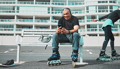 Buy stock photo Fitness, roller blade and senior man with smartphone, smile and guy on bench, headphones and relax. Exercise, mature male and gentleman outdoor, skater and cellphone for social media, music and break