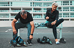 Roller skate, shoes and senior couple in city tie shoelace for sports, adventure and fitness hobby outdoors. Exercise, holiday and elderly man and woman with pain from skating, travel and journey