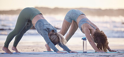 Buy stock photo Woman, friends and yoga stretching on beach for spiritual wellness, zen or workout together in nature. Women yogi in warm up stretch, svanasana pose or pilates for healthy exercise on ocean coast