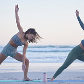 Woman, friends and yoga stretching on beach for spiritual wellness, zen ...