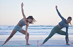 Woman, friends and yoga stretching on beach for spiritual wellness, zen or workout together in nature. Women yogi in warm up stretch, trikonasana pose or pilates for healthy exercise on ocean coast