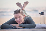 Woman, portrait and relaxing on beach for yoga, exercise or spiritual wellness lying on mat with bottle and towel. Happy female relax in fitness with smile for zen workout, training or mental health