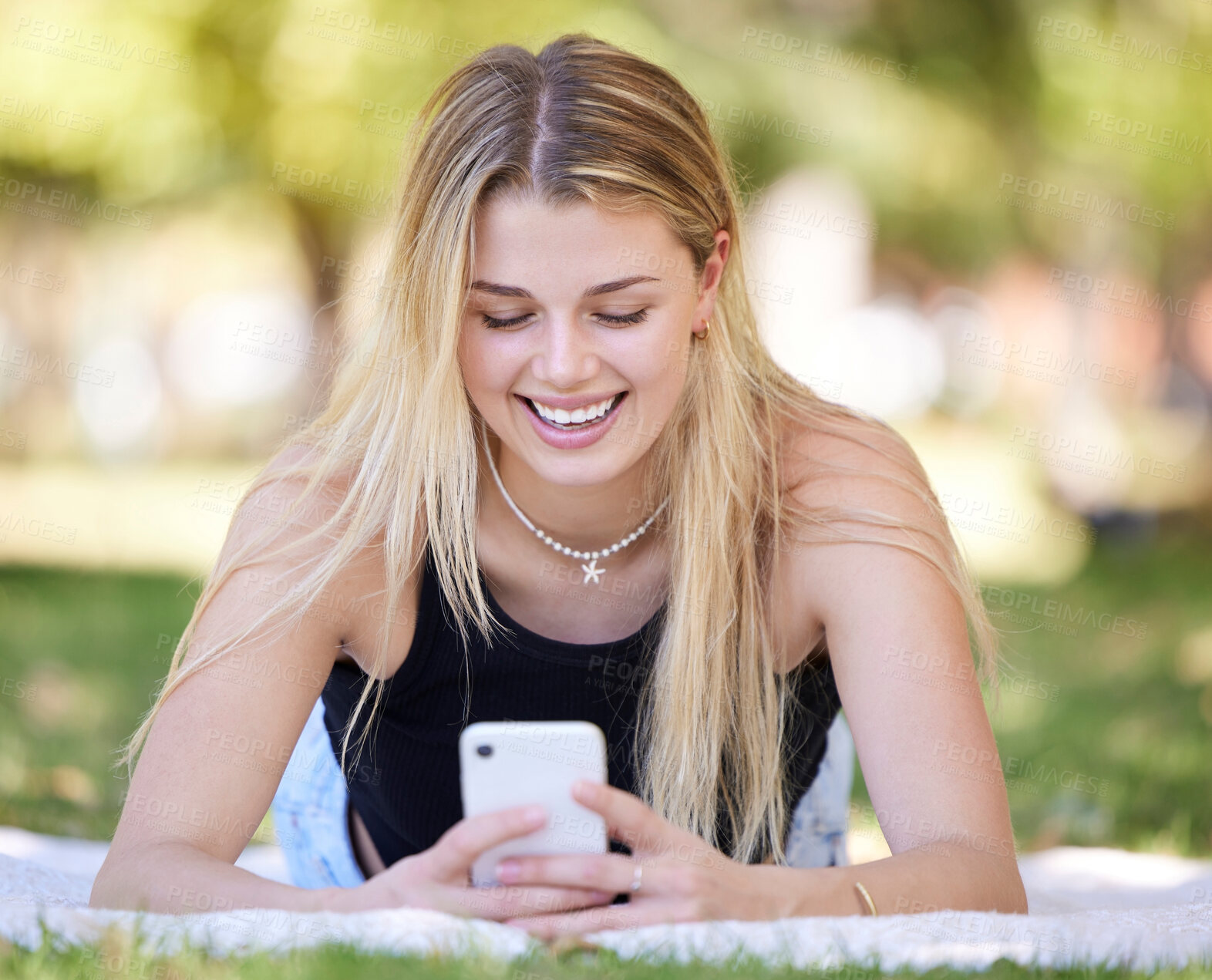 Buy stock photo Happy, relax or girl with phone in park with smile for online meme, reading comic blog or social media. Search, typing or woman with 5g smartphone for networking communication or funny news outdoors