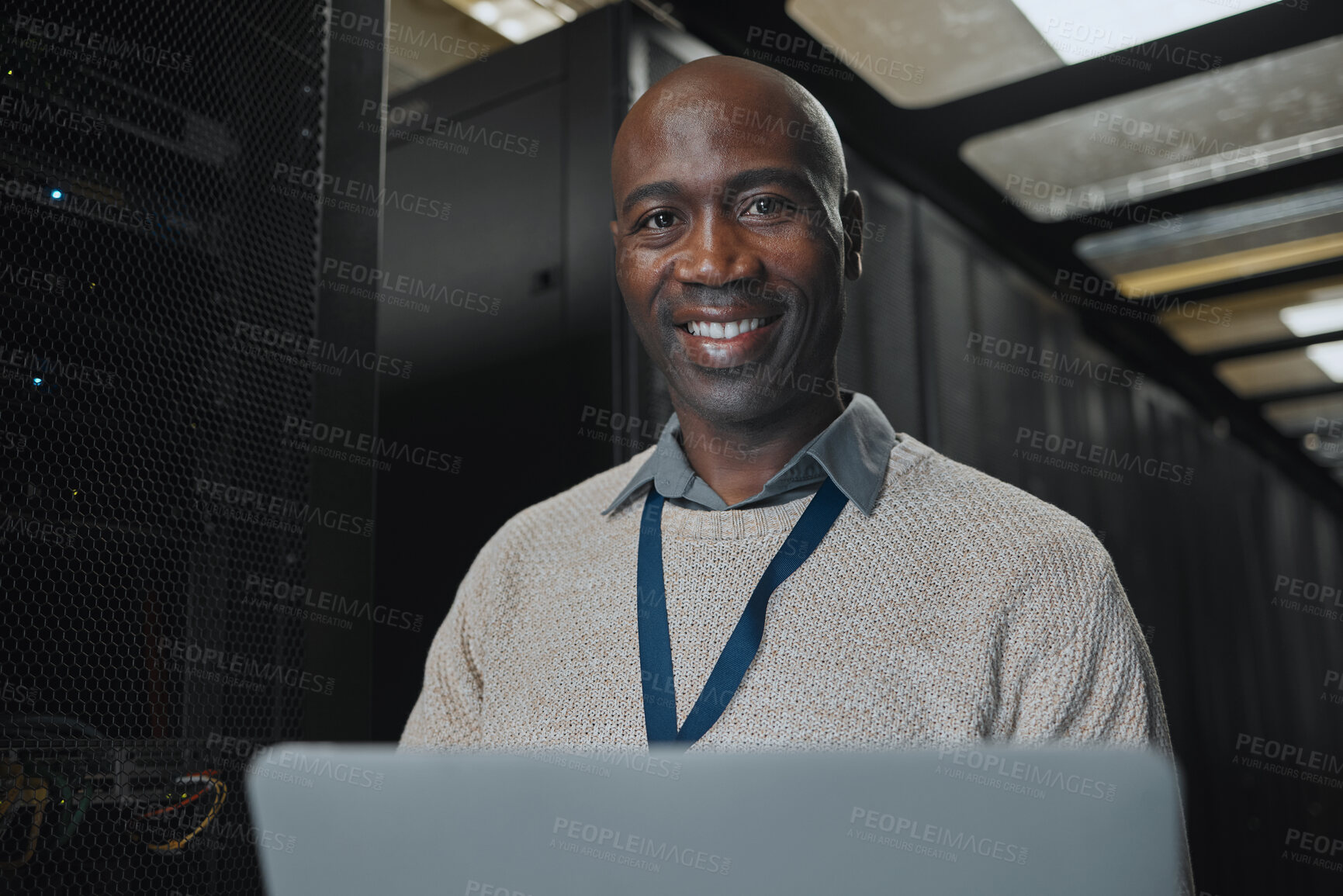 Buy stock photo Laptop, portrait and IT black man in server room for research, engineer working in dark data center lobby. Face, cybersecurity or analytics with male programmer problem solving or troubleshooting