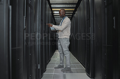 Buy stock photo Laptop, maintenance and server room with IT black man for research, engineer working in dark data center. Computer, cybersecurity and analytics with male programmer problem solving or troubleshooting