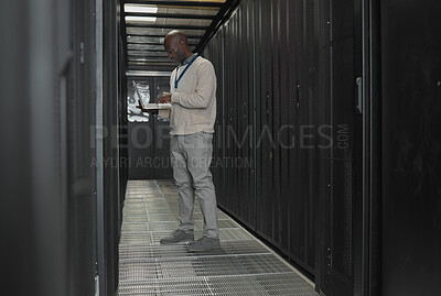 Buy stock photo Server room, data center or IT black man with laptop for research, engineer working in  dark server room. Computer, cybersecurity and analytics with male programmer problem solving or troubleshooting