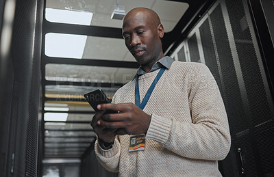 Buy stock photo Phone, search or IT black man in data center for research, communication or typing in dark server room. Serious, focus or male with smartphone for networking, social media or reading website content