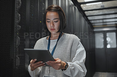 Buy stock photo Tablet, server room and security with a programmer asian woman at work on a computer mainframe. Software, database and information technology with a female coder working alone on a cyber network