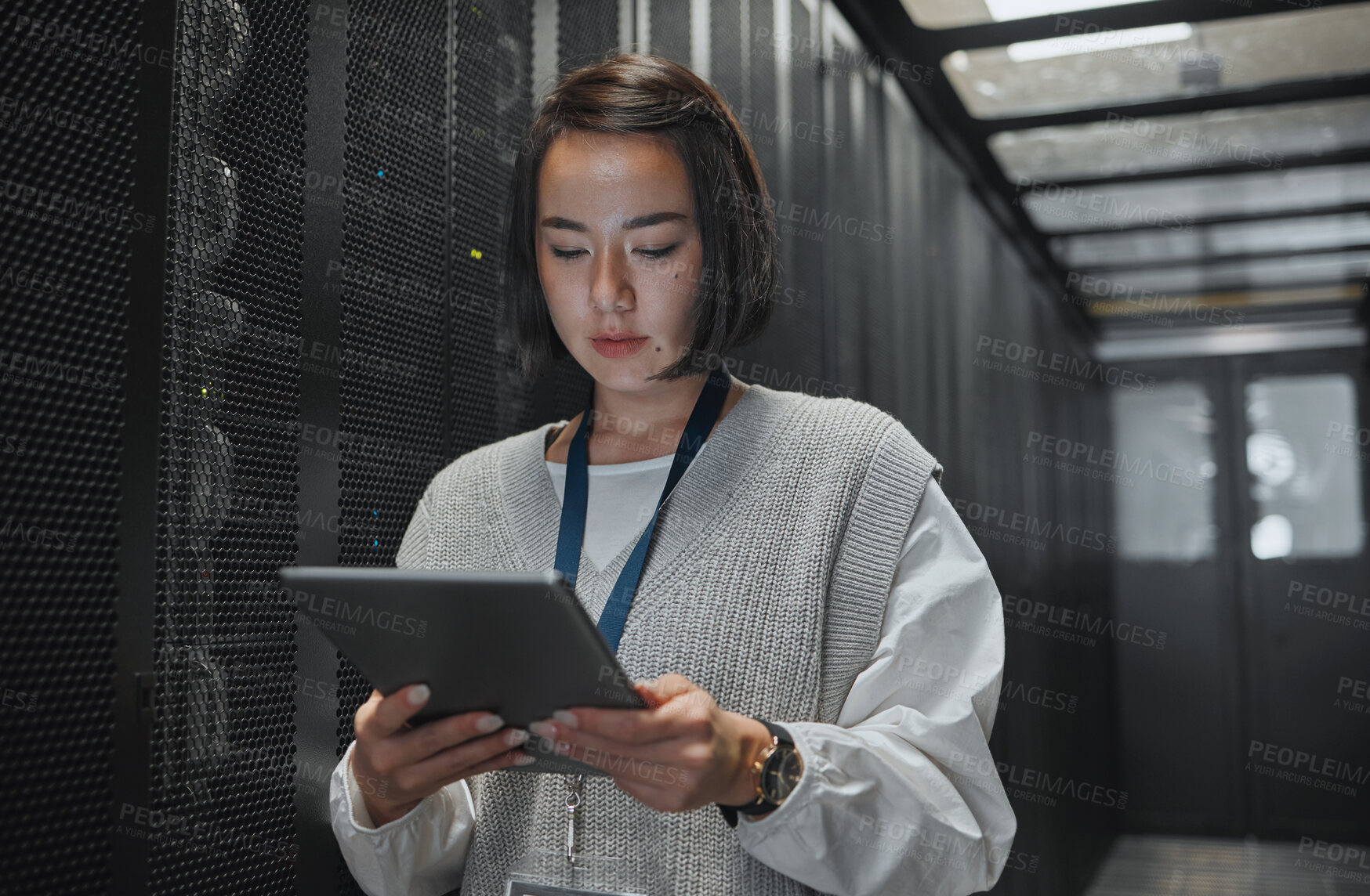 Buy stock photo Tablet, server room and security with a programmer asian woman at work on a computer mainframe. Software, database and information technology with a female coder working alone on a cyber network