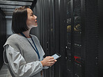 Tablet, server room and big data with a programmer asian woman at work on a computer mainframe. Software, database and information technology with a female coder working alone on a cyber network