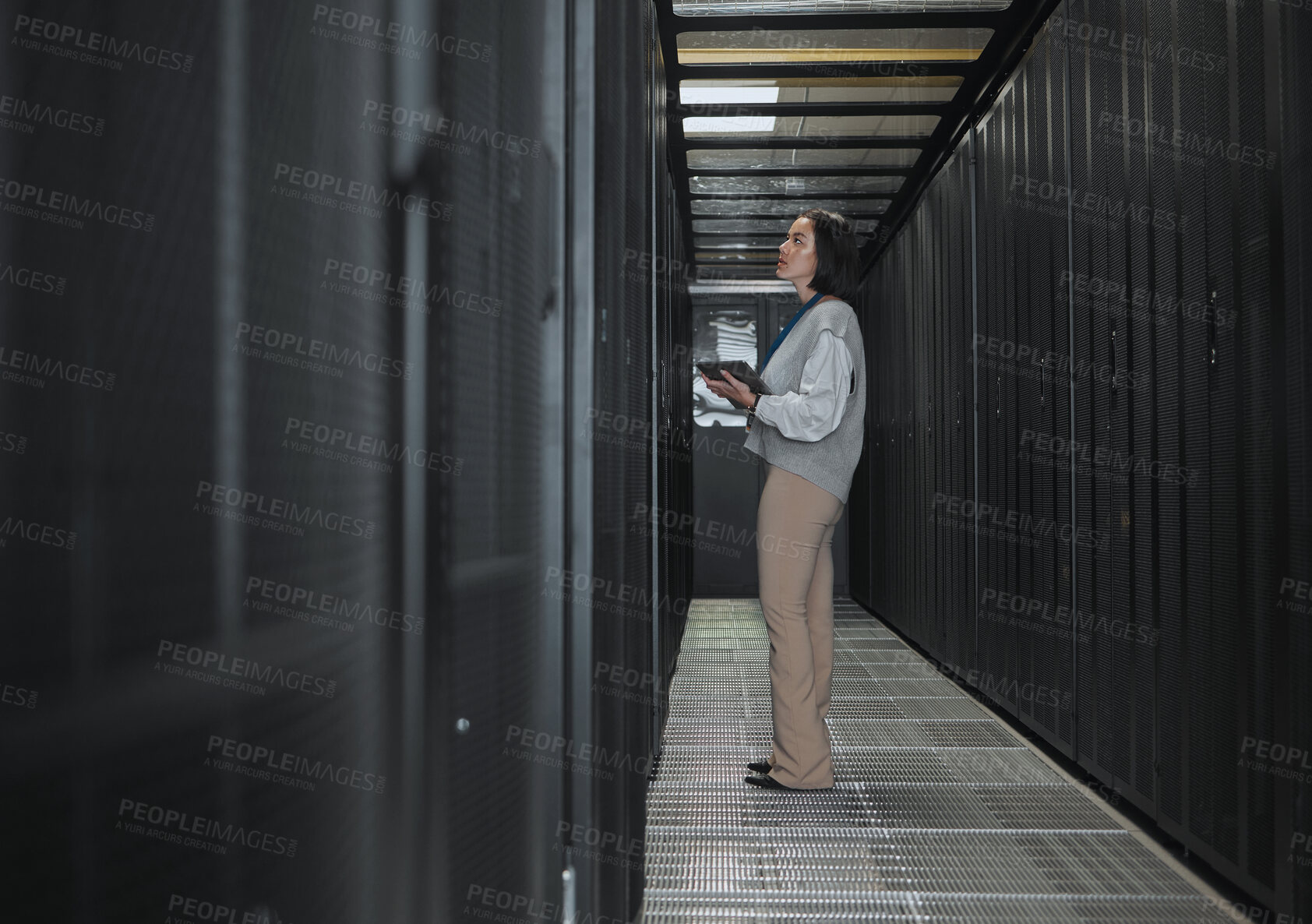 Buy stock photo Tablet, server room and storage with a programmer asian woman at work on a computer mainframe. Software, database and information technology with a female coder working alone on a cyber network