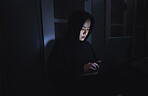 Hacker, server room and person on laptop for coding software, data center crime and cyberpunk in dark. Network hacking, woman or user in cybersecurity, information technology or programmer ransomware