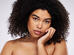 Skincare, beauty and portrait of black woman with hand on face, afro and advertising luxury makeup product promo. Dermatology, cosmetics and facial skin care on model isolated on studio background.