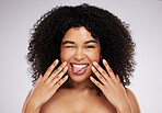 Black woman, tongue and afro in studio portrait with beauty, wellness and cosmetic skincare glow by background. Young gen z model, african and cosmetics with funny face, natural and healthy aesthetic