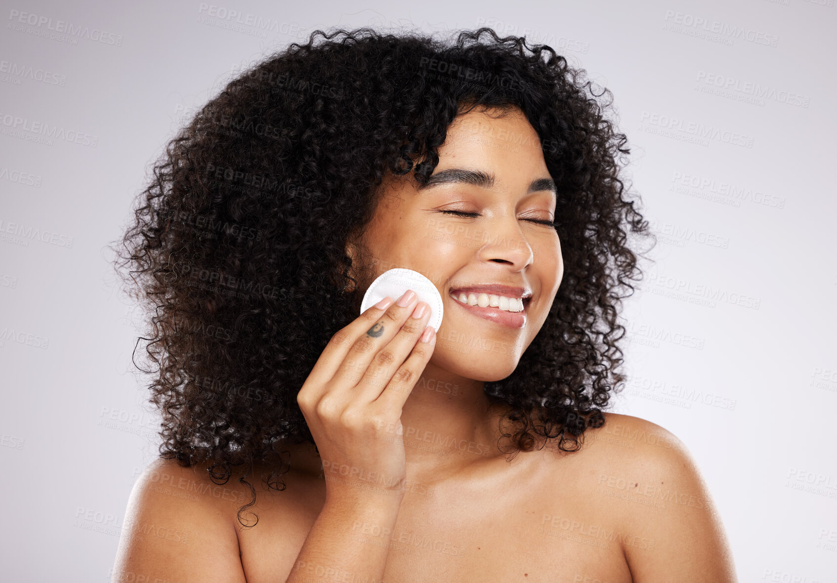 Buy stock photo Beauty, cotton pad and face of black woman with smile for wellness, skincare routine and healthy glow. Dermatology, luxury spa and happy girl with swab to remove makeup, cosmetics and facial products