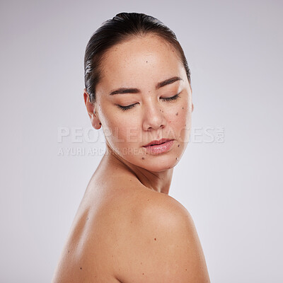 Buy stock photo Beauty, skincare and face of a woman in studio for cosmetics, dermatology and makeup for skin glow. Aesthetic asian model person with shine, mole and luxury facial self care for health and wellness