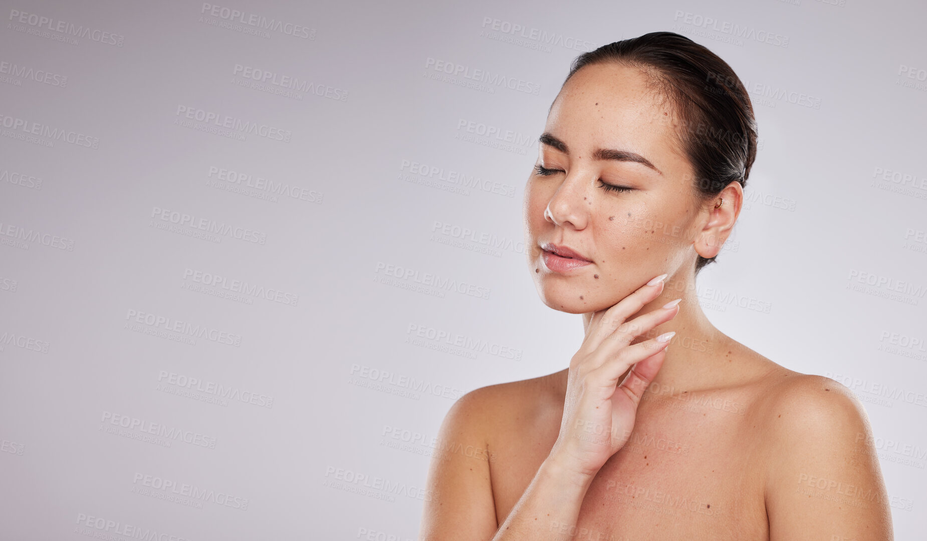 Buy stock photo Skincare, hand on face and woman with mockup space in studio for beauty, dermatology and cosmetics. Aesthetic asian model with makeup, skin glow and luxury self care facial results on grey background