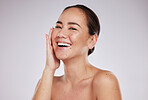 Asian woman, face and portrait of woman beauty in studio for skincare, dermatology and cosmetics. Happy aesthetic model smile with hand on skin for makeup and self care facial on grey background