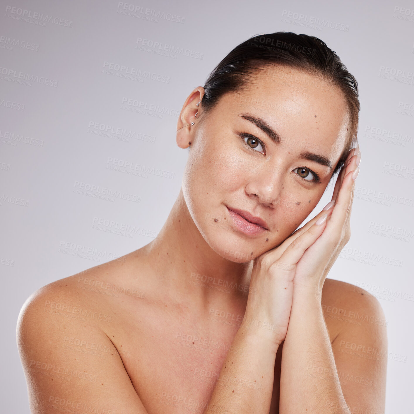 Buy stock photo Beauty, asian woman and face portrait for skincare in studio with dermatology cosmetic for skin glow. Aesthetic model person with hands for makeup and facial self care for wellness on grey background