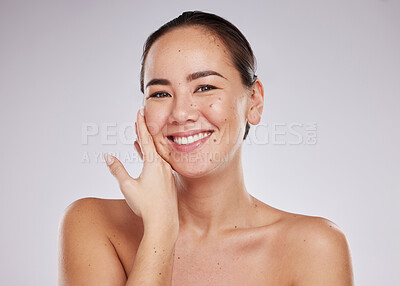 Buy stock photo Face portrait, smile and skincare of Asian woman in studio isolated on a gray background. Makeup, beauty cosmetics and happy female model with glowing, healthy or flawless skin after facial treatment