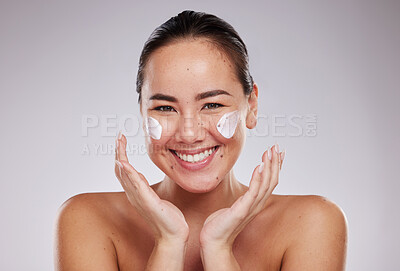 Buy stock photo Skincare, portrait and face cream for woman in studio for wellness, grooming and cosmetics on grey background. Facial model and asian girl relax with luxury beauty, skin and treatment with product