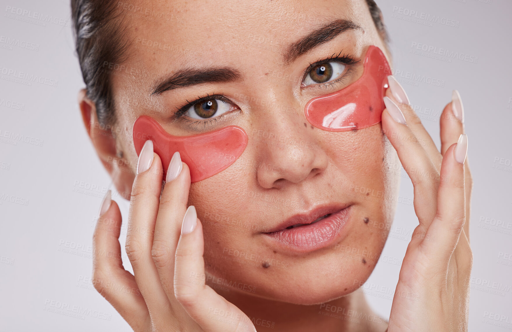 Buy stock photo Skincare, face and woman with eye patches in studio isolated on a gray background. Dermatology, cosmetics and portrait of young female model with facial pads or products for beauty or skin treatment.