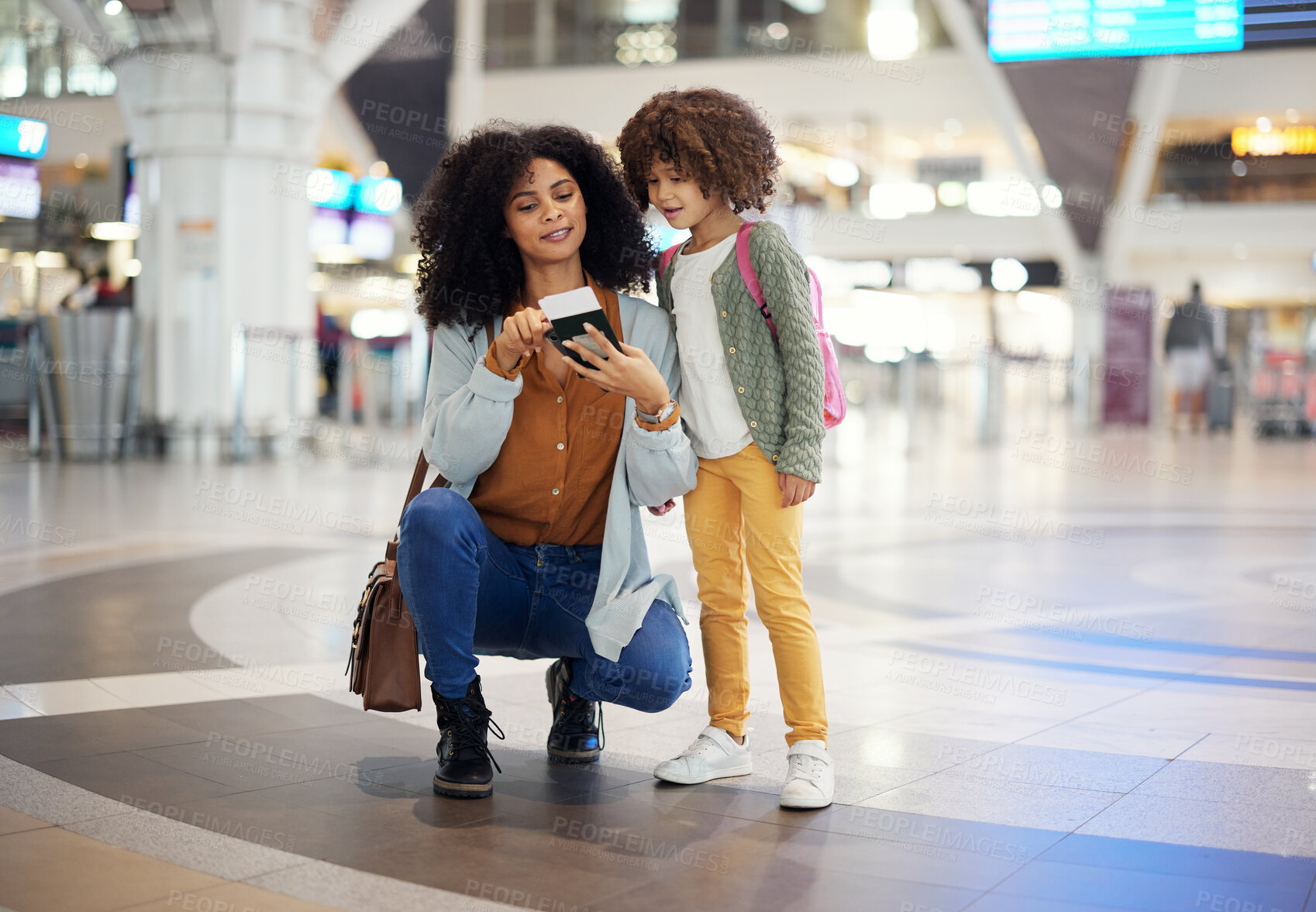 Buy stock photo Travel, passport and mother with her child in the airport checking their boarding pass together. Trip, technology and woman browsing on a cellphone with girl kid while waiting for flight in terminal.