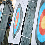 Bullseye target paper, outdoor and field at shooting range for weapon ...