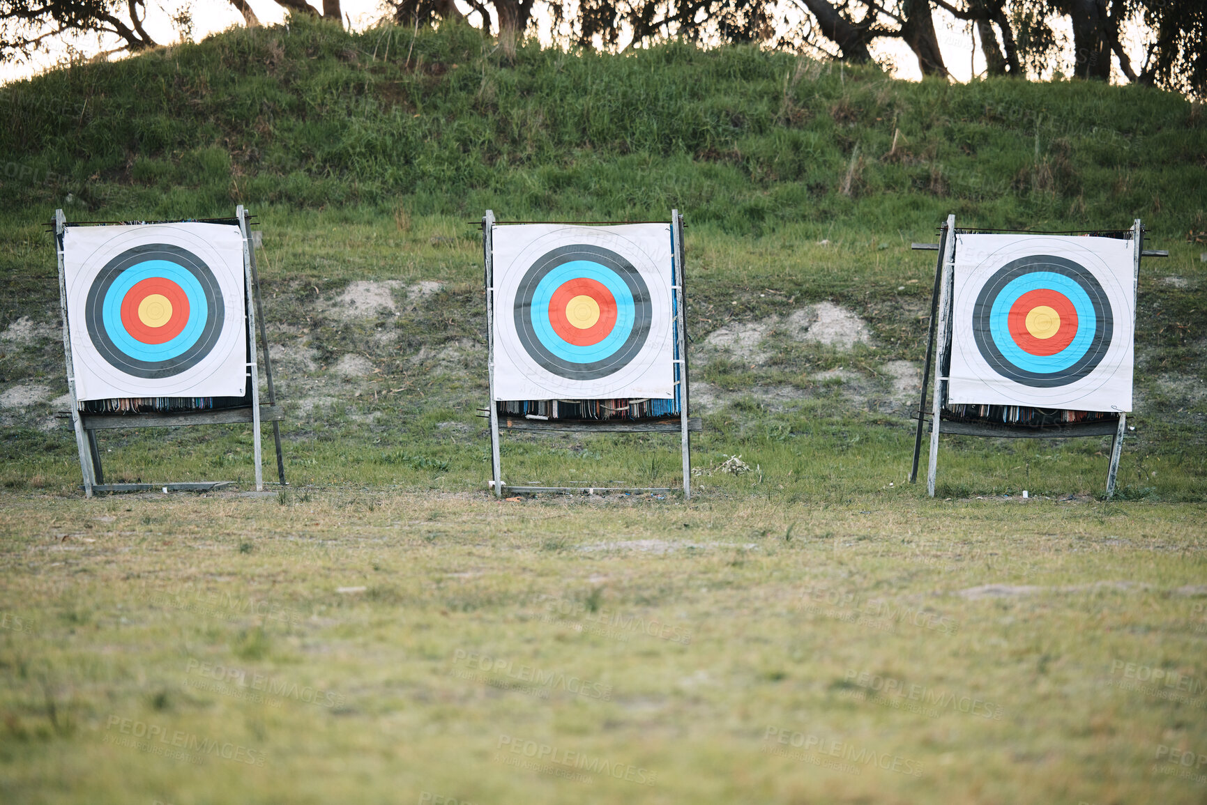 Buy stock photo Bullseye target board, outdoor and field at shooting range for weapon training, aim and accuracy. Sports, archery and poster for gun, bow and arrow at academy for police, army or security in nature