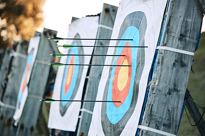 Buy stock photo Arrows in archery circle or target for competition, game or learning in field outdoor for sports background. Sport event, icon or eye goal with arrow on board for gaming, adventure and shooting