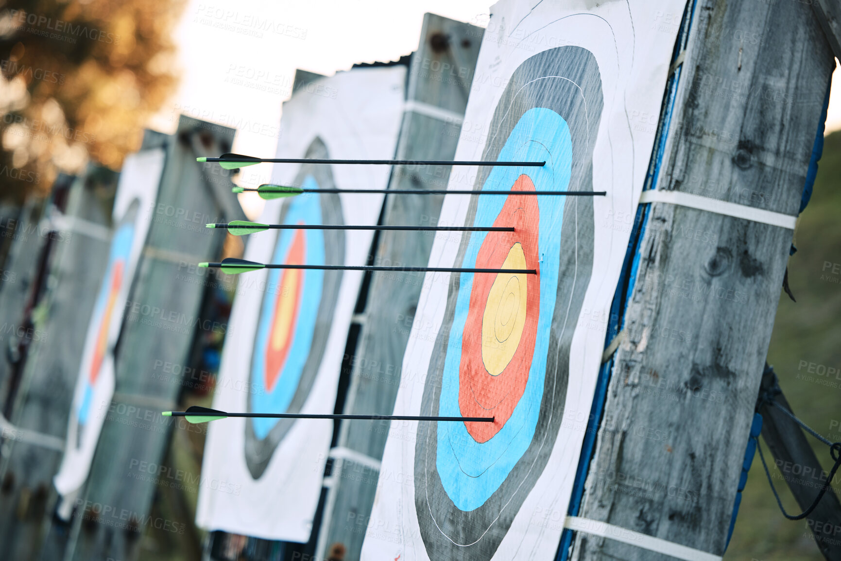 Buy stock photo Arrows in archery circle or target for competition, game or learning in field outdoor for sports background. Sport event, icon or eye goal with arrow on board for gaming, adventure and shooting