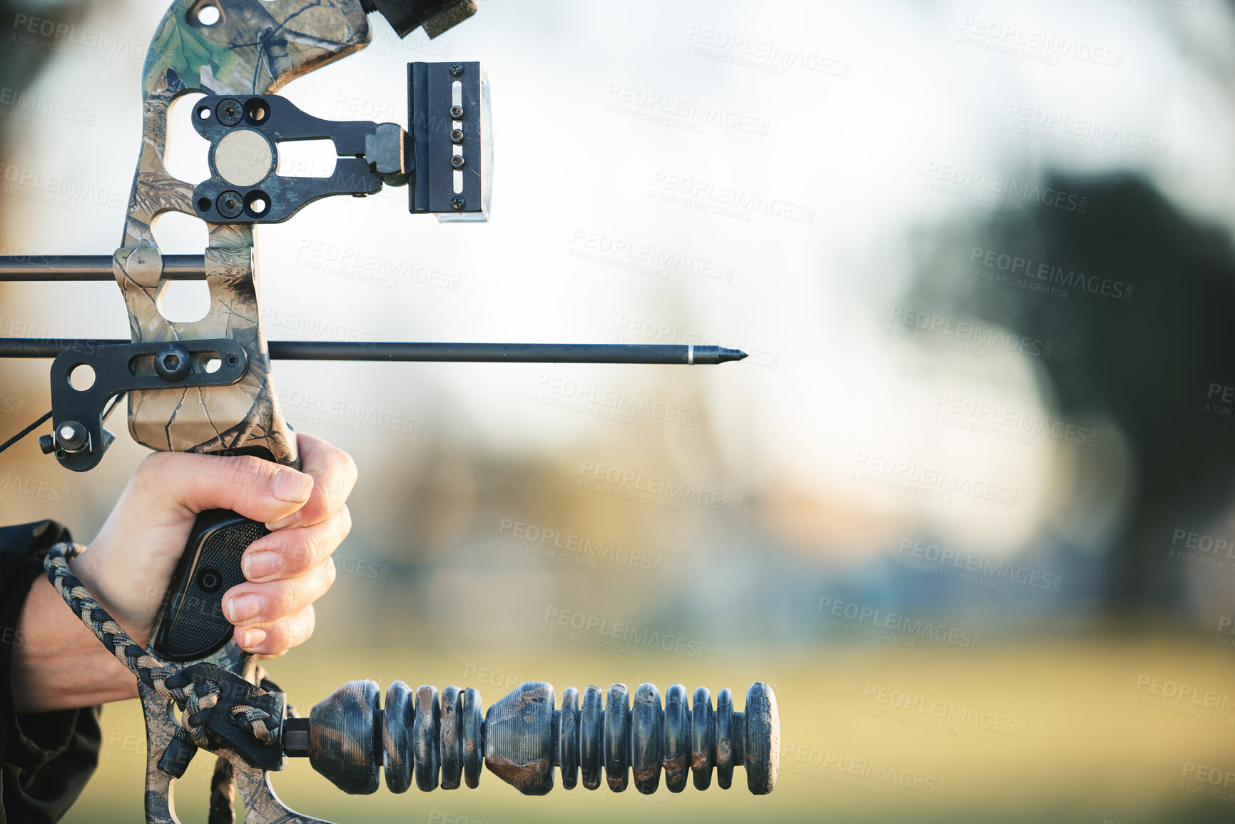 Buy stock photo Archery bow and closeup of person at shooting range for competition, game or learning in field or outdoor sports.  Woman and arrow for gaming, adventure and sport hunting with aim and target practice