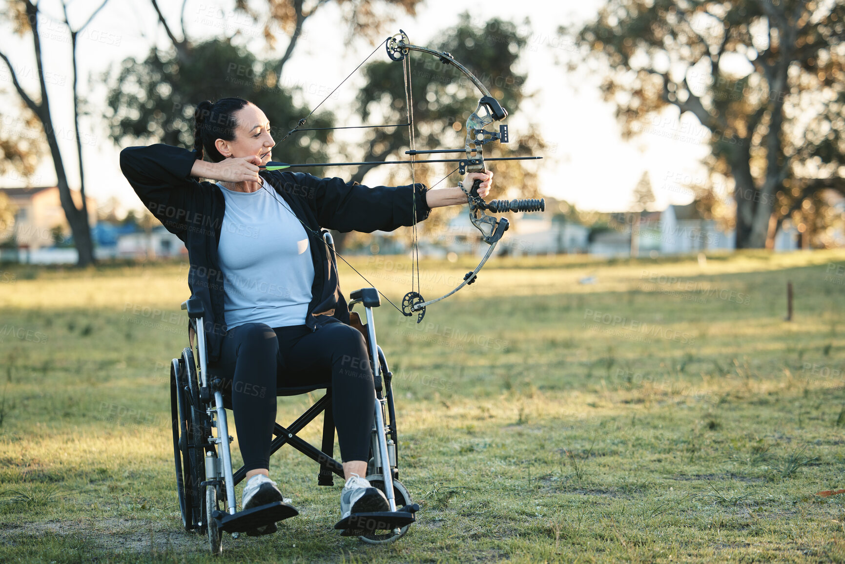 Buy stock photo Outdoor archery, disabled woman in wheelchair and challenge for active sports lifestyle in Canada. Person with disability in a park, fitness activity to exercise arms with bow and arrow for hobby