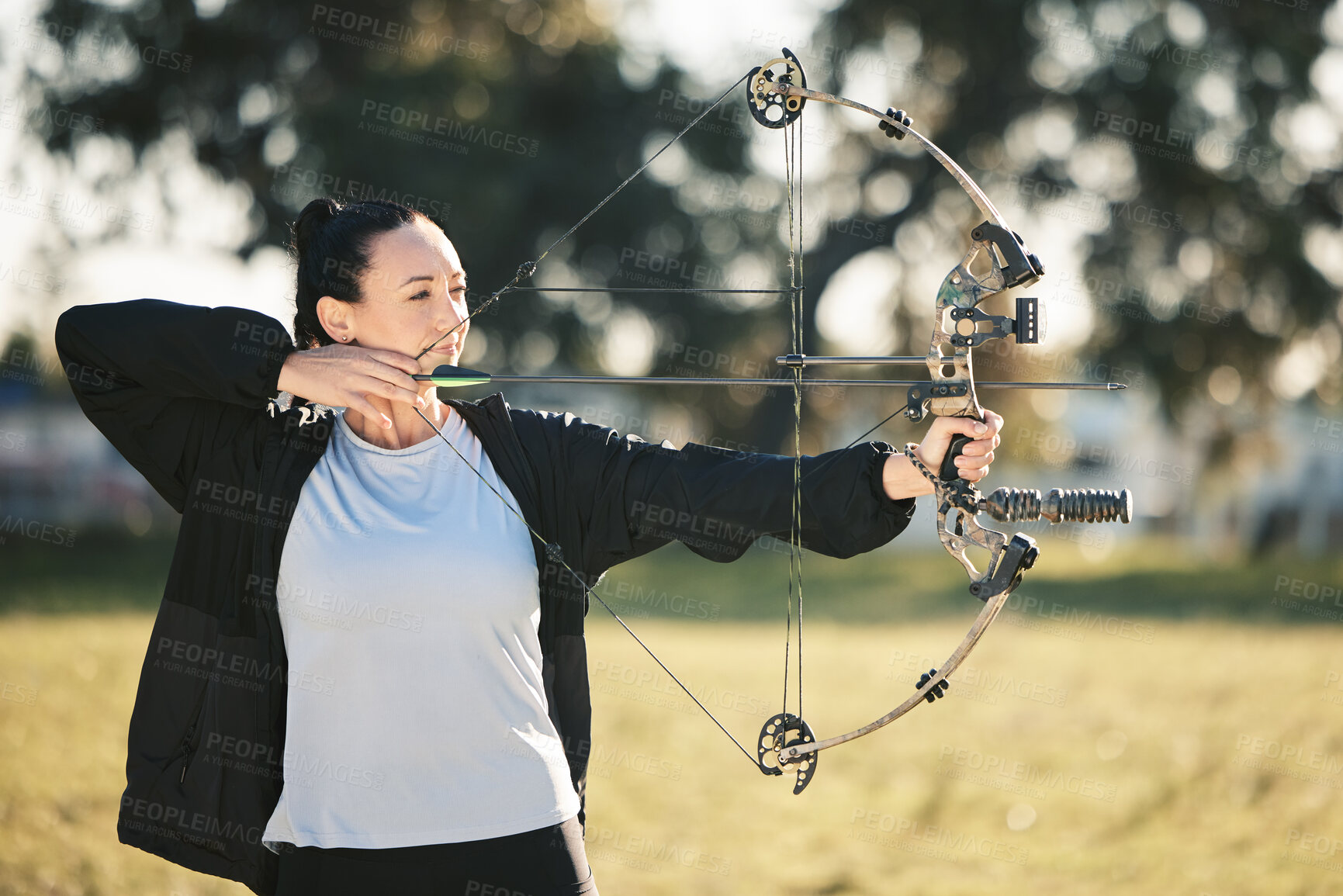 Buy stock photo Happy person, bow or arrows aim in sports field, shooting range or gaming nature in hunting, hobby or exercise. Archery, woman or athlete smile with weapon in target training, competition or practice