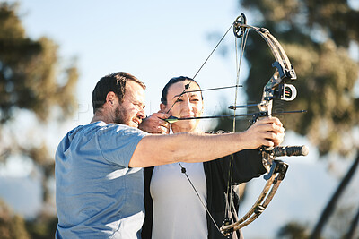 Buy stock photo Archery, shooting range and sports training to aim with a woman and man outdoor for target practice. Archer and athlete person with focus on field for competition or game to shoot arrow for action