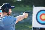 Man, firearm training and target for outdoor challenge, goals and aim for police, army or security academy. Shooting expert, pistol or gun for sport, safety and combat exercise in nature with vision